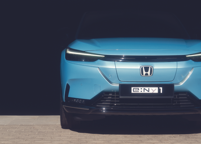 Blue Honda e:ny1 on a road